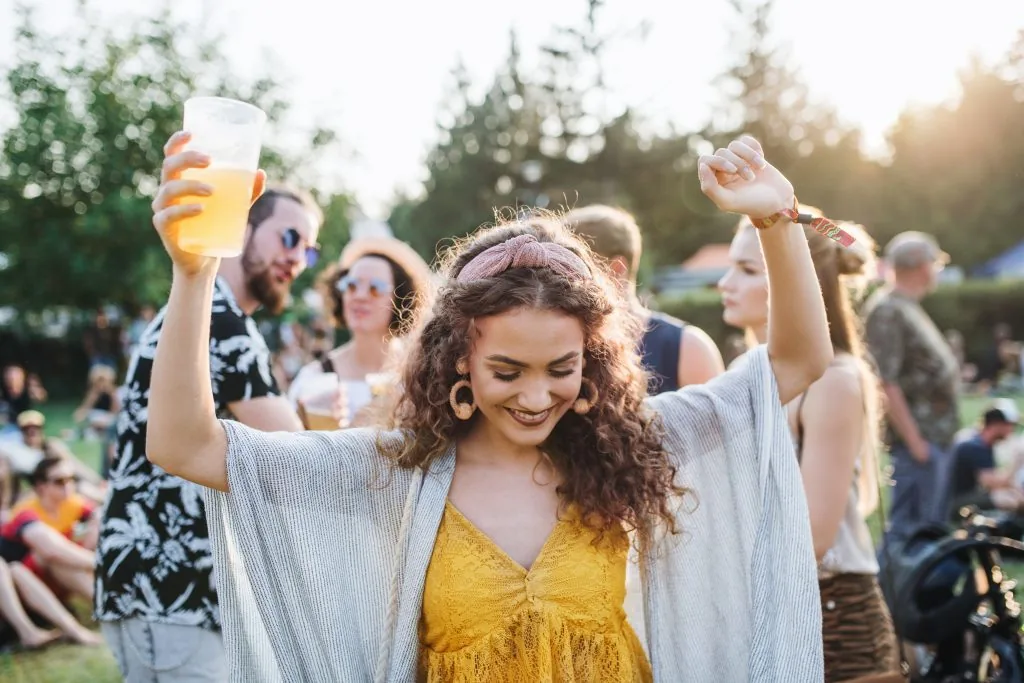 a-young-woman-with-drink-dancing-at-summer-festiva-2022-02-02-04-48-56-utc-1024x683